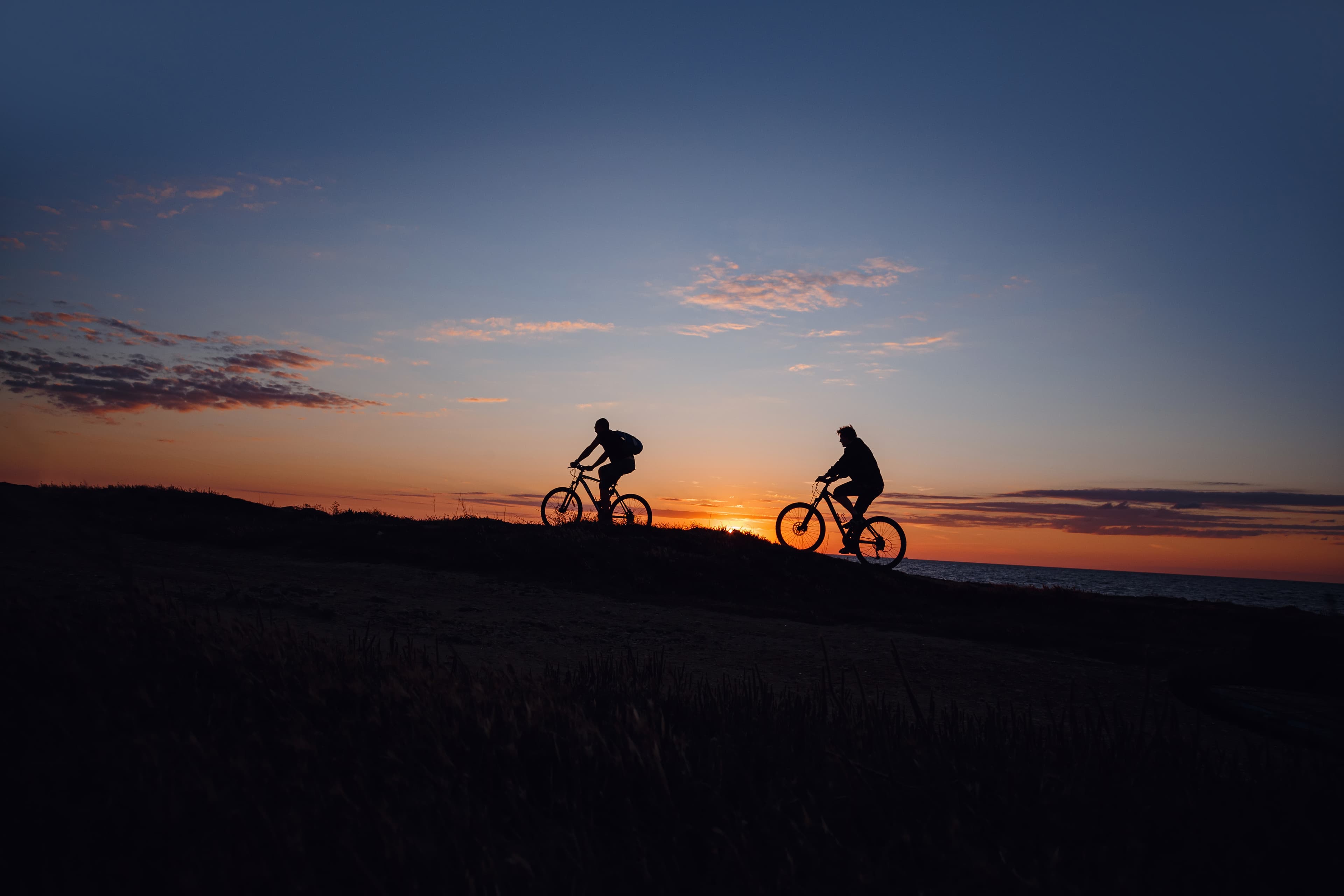 Riders on OCTANE cycles at sunset